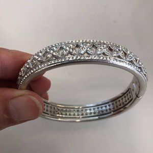 Nadri half pave Cubic Zirconia Hinged Oval “X” Bangle in White Rhodium Brass